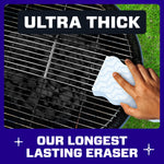 Hand scrubbing a grill grate with an ultra-thick patterned Magic Eraser pad over charcoal grill