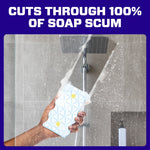 Bold text banner claiming cuts through soap scum above a hand holding a sudsy Magic Eraser pad under a showerhead
