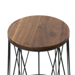 Close overhead crop showing the grain and finish of the round acacia wood tabletop on a metal-framed plant stand