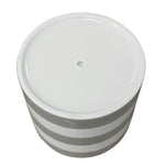 Bottom view of a Mainstays Andrew striped ceramic planter showing a central drainage hole on glossy white base