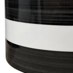 Cropped detail showing midsection of a black and white horizontal striped ceramic planter