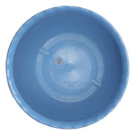 Top-down view into a blue plastic planter showing the interior and drainage plug