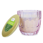 Mainstays citronella candle shown in a pink faceted glass jar with the gold lid leaning against the jar