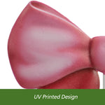 Tight close-up of the left upper loop of a pink metal bow showing paint gradient and texture
