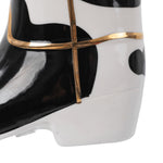 Close-up of the boot toe area with black cowhide spots and raised gold accent lines