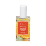 Clear rectangular Mainstays Cranberry Mandarin room spray bottle with orange label and white cap on white background