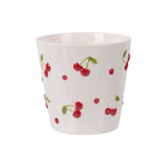 Cream ceramic round planter decorated with raised red cherry motifs on a white background