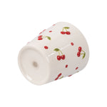 Cream ceramic planter lying on its side showing exterior cherry pattern and glossy finish
