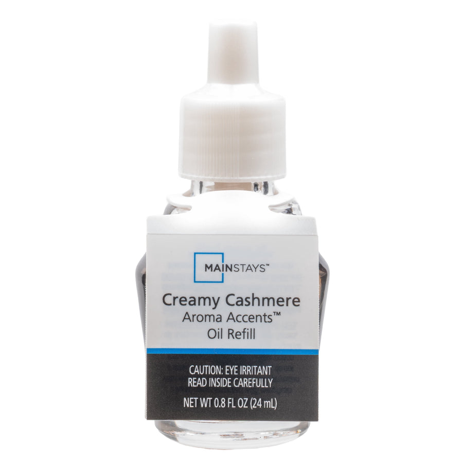 Clear glass refill bottle with white plastic cap and Mainstays Creamy Cashmere label on white background.