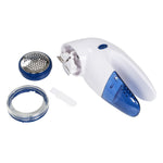 Disassembled Mainstays fabric shaver showing removable perforated head, ring, brush and body