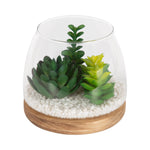 Glass tabletop terrarium with three faux green succulents, white pebble base and round wood platform