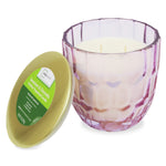 Mainstays geranium & citronella candle in pink faceted glass jar with gold lid removed and placed beside