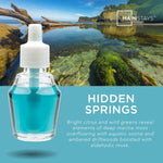 Promotional graphic showing a close-up bottle of blue-green oil over a coastal landscape with the Mainstays logo and Hidden Springs fragrance name.