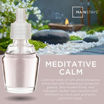 Glass Mainstays oil refill bottle over a zen garden background with 'Meditative Calm' product text
