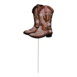 Pair of decorative metal cowboy boots mounted on a thin white garden stake, isolated on white.