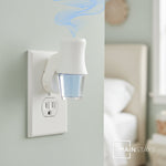 Plug-in diffuser with a Mainstays oil refill inserted, emitting stylized blue scent wisps in a bedroom setting.