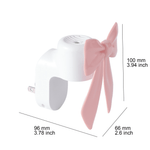 White plug-in fragrance warmer with a pink bow decoration shown with dimensional measurements in millimeters and inches