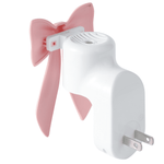 Angled side view of a white plug-in fragrance warmer with a glossy pink bow accent and visible prongs