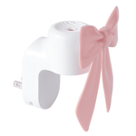 Three-quarter view of a white plug-in warmer featuring a pink bow decorative front and curved body