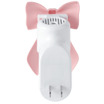Top-down view of a white plug-in warmer showing ventilation slots with a pink bow decorative cover attached
