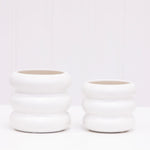 Two white ceramic bubble planters of different sizes shown side by side on a white surface