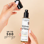 Hands removing cap from Maison & Muse Marilyn spray bottle with text overlay stating up to 500 sprays