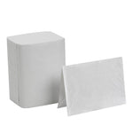 Stacked white interfold napkin pack alongside a single folded napkin showing textured surface on white background