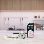 Lifestyle kitchen scene showing a roll of bags and a Matter compostable 3 gallon box on a countertop