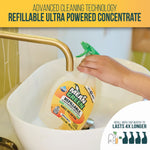 Person holding a Mean Green refillable concentrate bottle under a faucet demonstrating filling the water chamber in a sink.