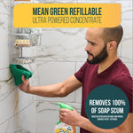 Person cleaning tiled shower wall with a cloth and a Mean Green refillable bottle visible in foreground, product headline above.