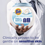 Person in a white coat holding a tub of Tide PODS Free & Gentle with claim about being gentle on sensitive skin