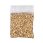 Clear mesh sachet filled with coarse beige granules shown against a white background