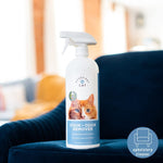 Messy Pet Cat Stain + Odor Remover bottle placed on a blue upholstered chair with an upholstery cleaner icon