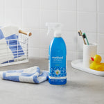 Method Antibac spearmint bathroom cleaner bottle staged on a bathroom counter with towel, toothbrush holder and rubber duck
