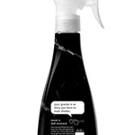 Close-up of a black marble-pattern Method spray bottle showing label text and a speech-bubble graphic about shiny granite.