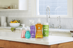 Kitchen countertop scene showing several Method cleaning and hand soap products, including an orange citron spray bottle among them.