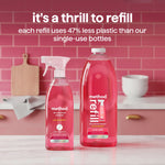Method pink grapefruit refill bottle and spray bottle staged on a pink-tiled kitchen counter with refill messaging