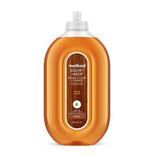 Clear oval bottle of Method Squirt + Mop wood floor cleaner with almond-scent label and amber liquid
