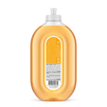 Rear view of a clear amber-orange Method Squirt + Mop hard floor cleaner bottle showing ingredient text and barcode