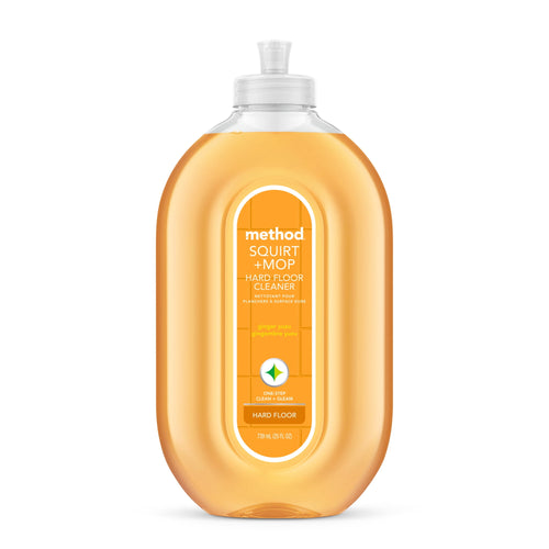 Clear amber-orange Method Squirt + Mop hard floor cleaner bottle with front label and flip-top cap on white background