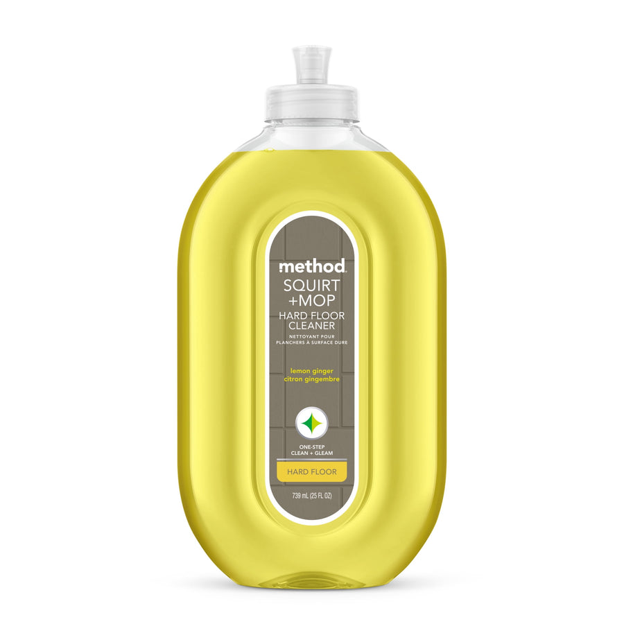 Clear oval bottle of Method Squirt + Mop hard floor cleaner with yellow lemon-ginger liquid and front label