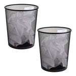 Two black metal mesh round wastebaskets shown filled with crumpled paper on white background