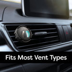 Close-up of a Refresh Your Car mini diffuser clipped to a vehicle air vent, showing the black housing and teal insert.