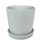 Mint semi-matte cylindrical ceramic planter seated in a matching saucer, angled front view on white