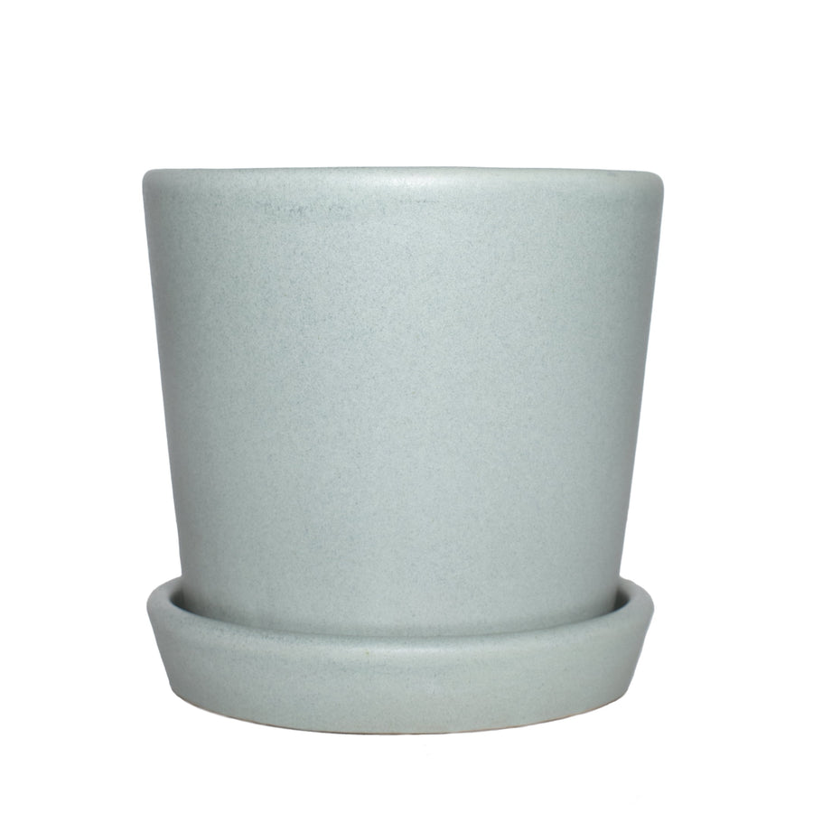 Semi-matte mint ceramic plant pot with matching saucer on white background, front view