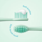 Two toothbrush heads shown in profile on a pale mint background with callouts for ‘soft bristles’ and ‘slim brush head’