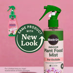 Close-up of Miracle-Gro Indoor Plant Food Mist bottle with badge announcing 'Same product with new look' on a pink background.