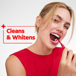 Person brushing teeth with a red Colgate Optic White toothbrush alongside 'Cleans & Whitens' text