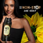 Model holding a black Downy Unstopables N.30 bottle beside large stylized yellow flowers and '24 HR NON-STOP' text
