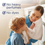 Smiling woman and child holding a towel near a washing machine with copy stating "No heavy perfumes" and "No dyes"
